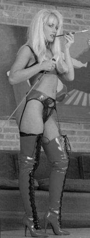 woman smoking with a cigarette holder and thigh high pvc boots